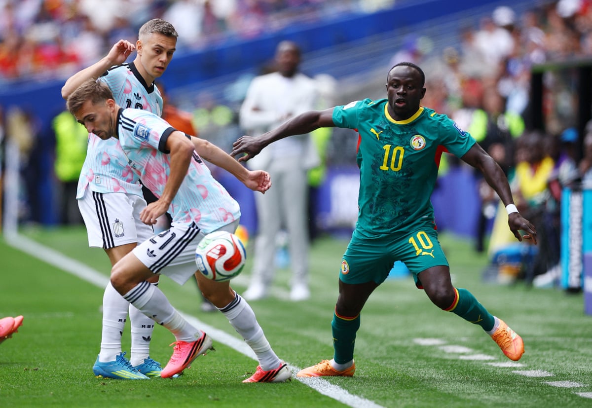 Sadio Mane in action with Belgium's Timothy Castagne and Leandro Trossard