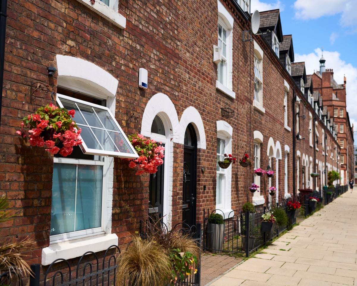 Pretty street of brick terrace houses with flower baskets