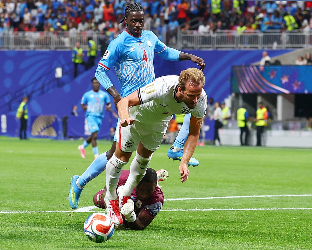 Harry Kane goes down in the box after being clipped by the goalkeeper.