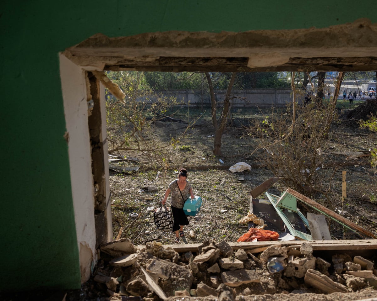 A woman walks into a residential building damaged following a Russian air attack on the Ukrainian capital of Kyiv.