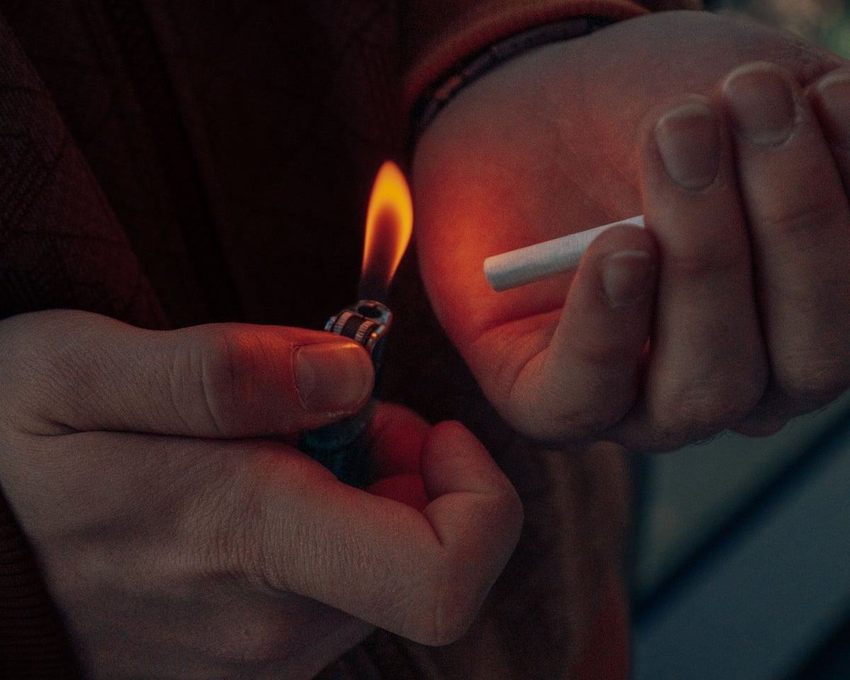 a person lights a cigarette