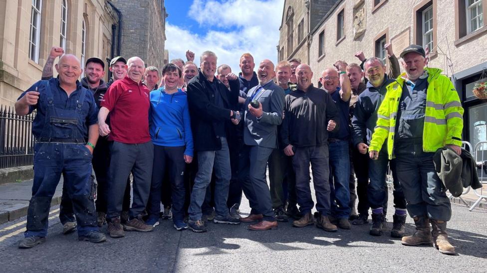 A group of men punching the air on the streets of Jedburgh