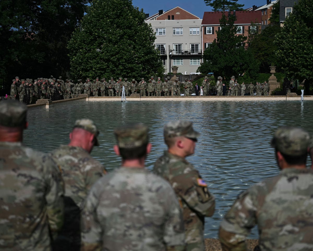 Members of the National Guard wait for the arrival of Pete Hegseth as he hosts a