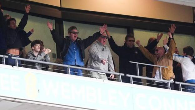 Noel and Liam Gallagher celebrating Manchester City's FA Cup final win at Wembley Stadium, with a little help from their friends