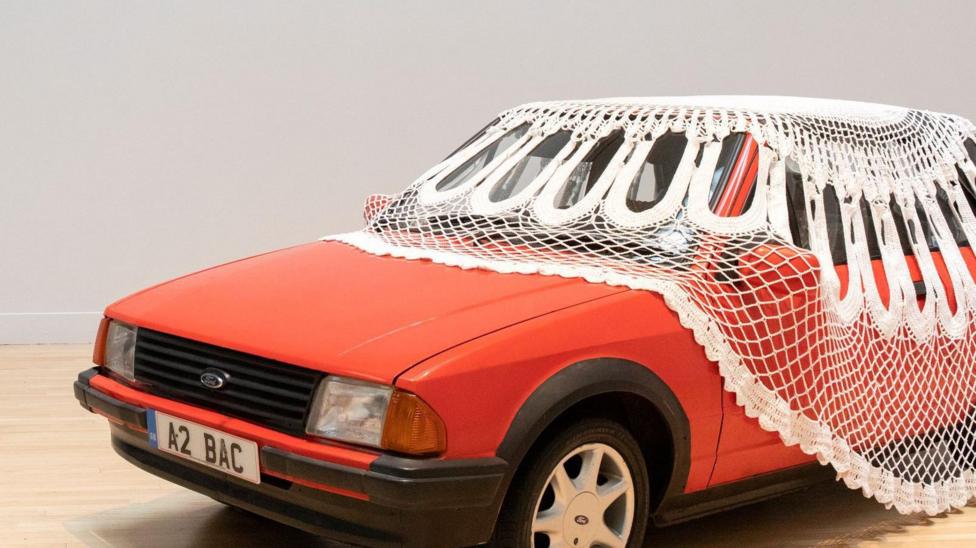 A red car with a doily over, part of Jasleen Kaur's Turner Prize-winning exhibition