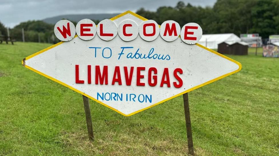 A white sign that reads: 'Welcome to fabulous Limavegas Norn Iron'