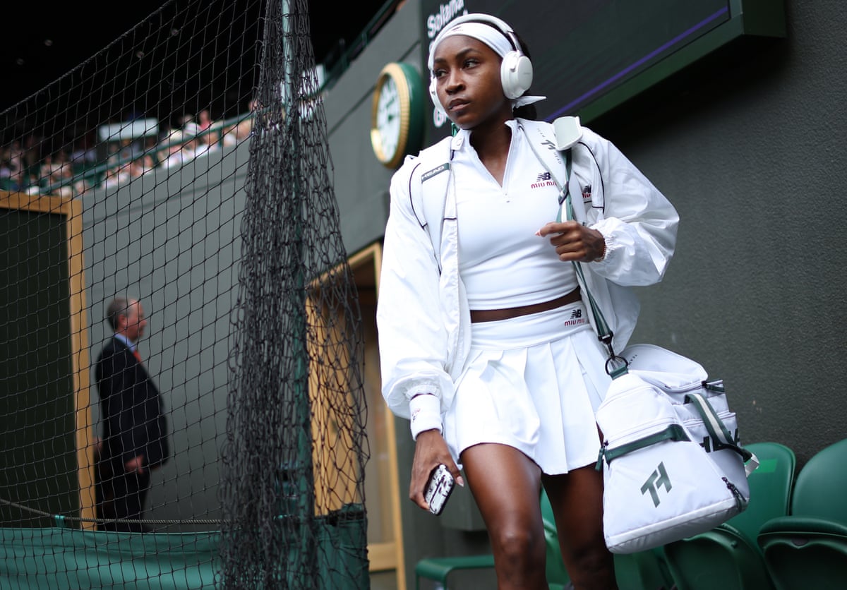 Gauff in headphones wearing Miu Miu/New Balance outfit