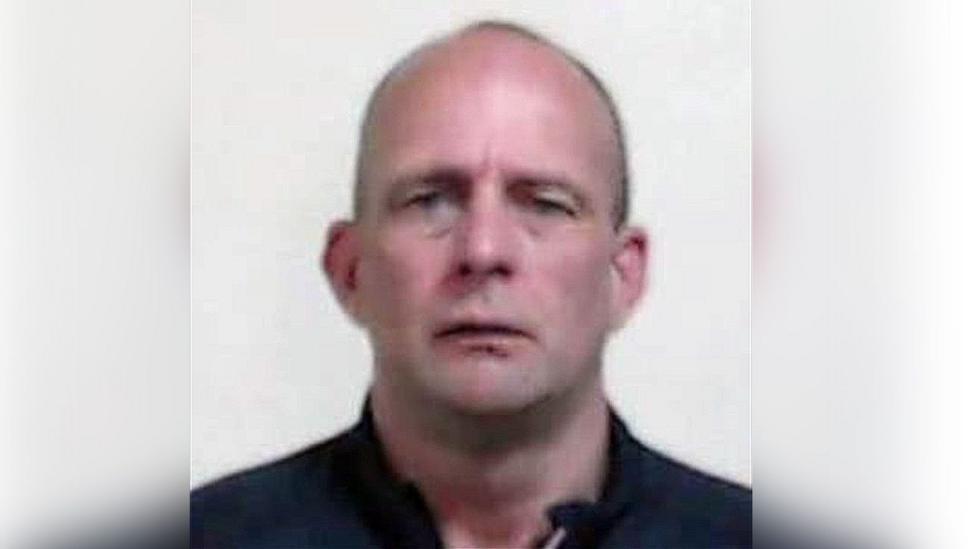 A head shot of David Brown, a man with a shaven head looking directly into the camera.