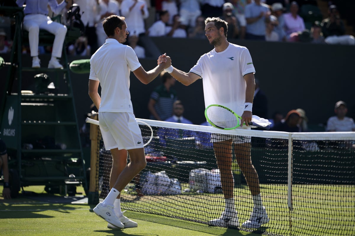 Jan-Lennard Struff (left) shakes hands with Daniil Medvedev after beating the Russian