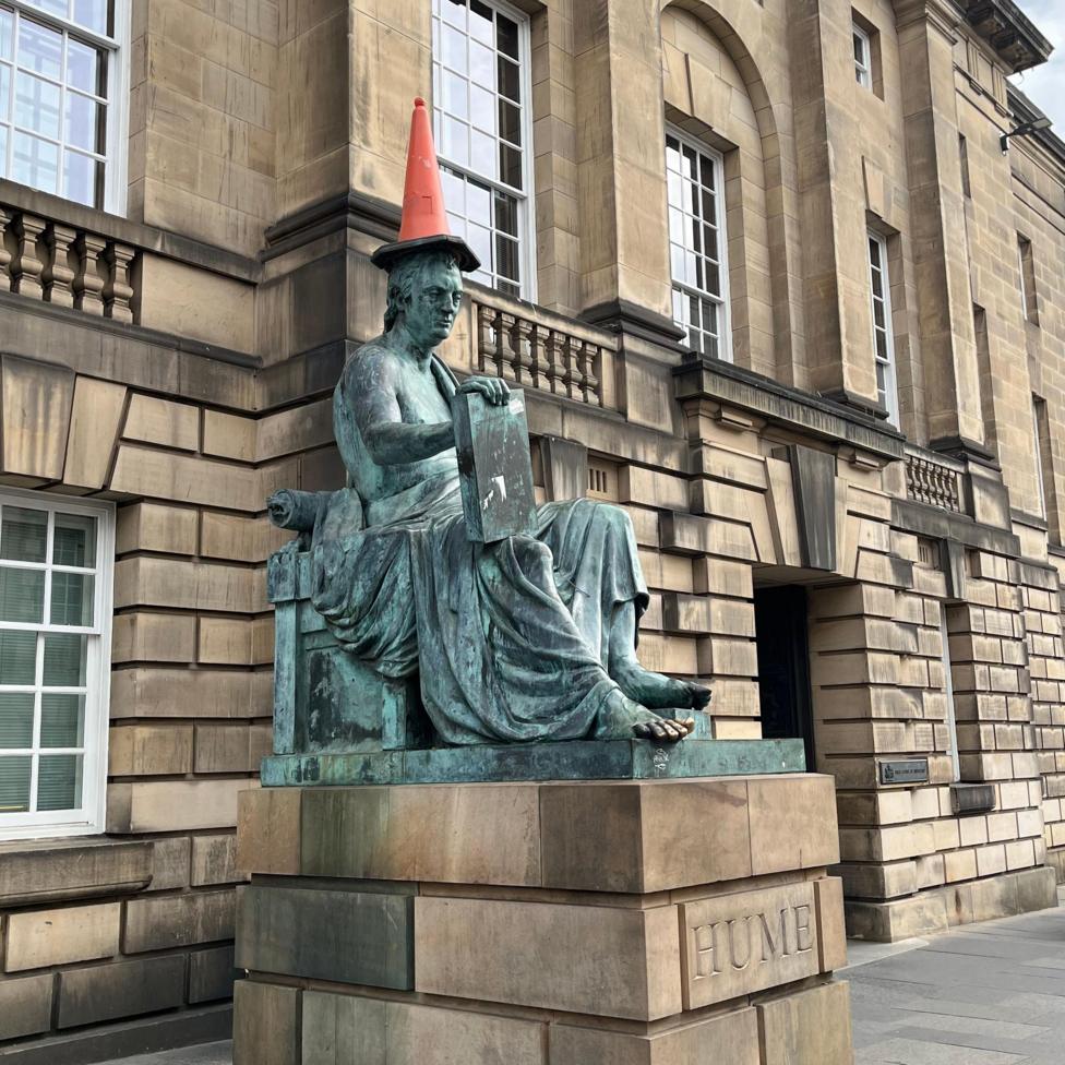 The David Hume statue on the Royal Mile with a cone on its head.