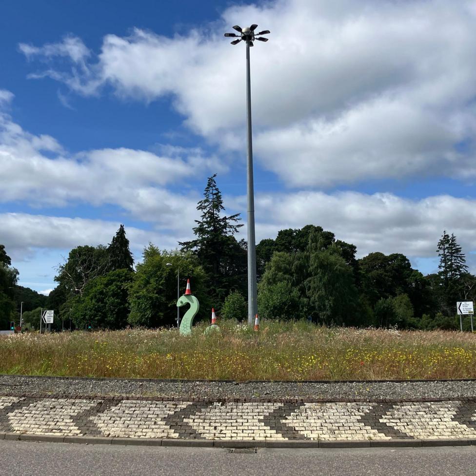 A Nessie statue in the middle of a roundabout in Inverness