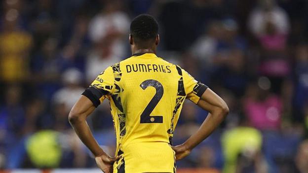 A rear view of Denzel Dumfries in a yellow Inter Milan strip with his name on it and the number two
