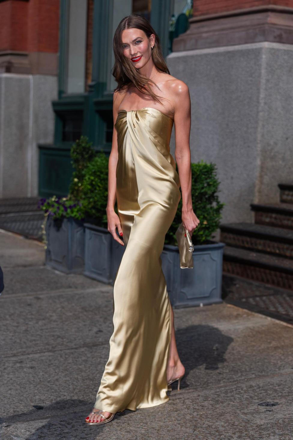 Karlie Kloss in a long strapless gold dress