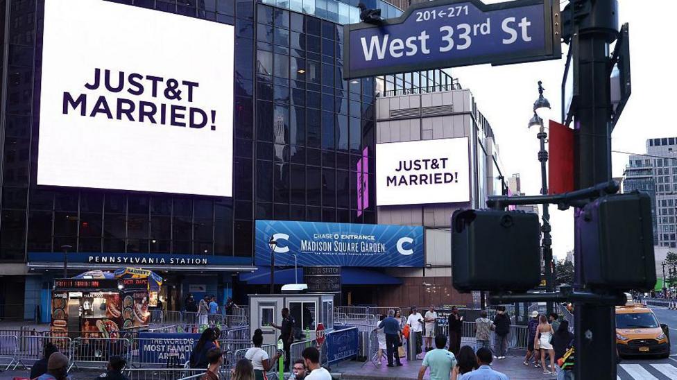 A giant screen shows the message