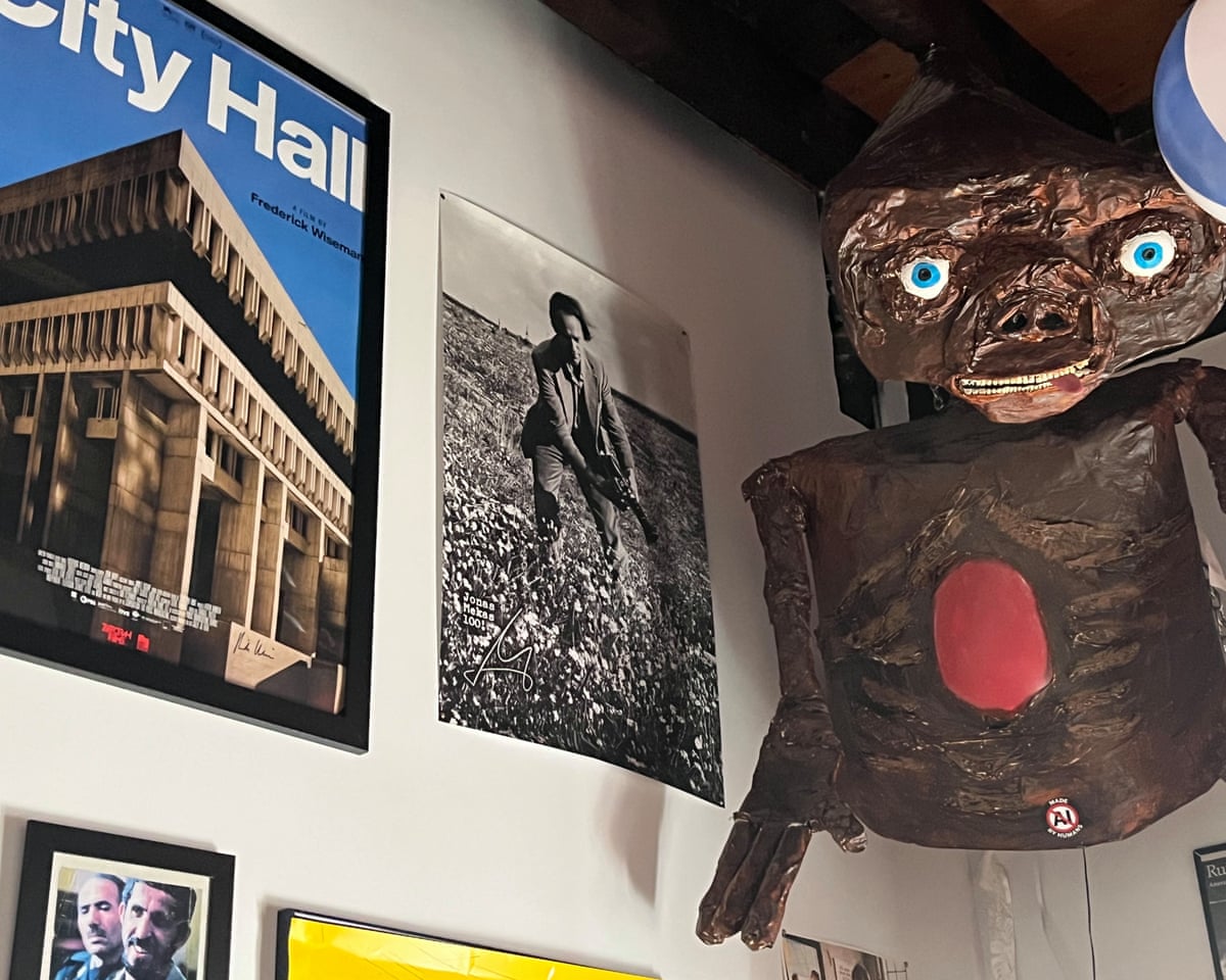 Pictures and alien model hanging on wall