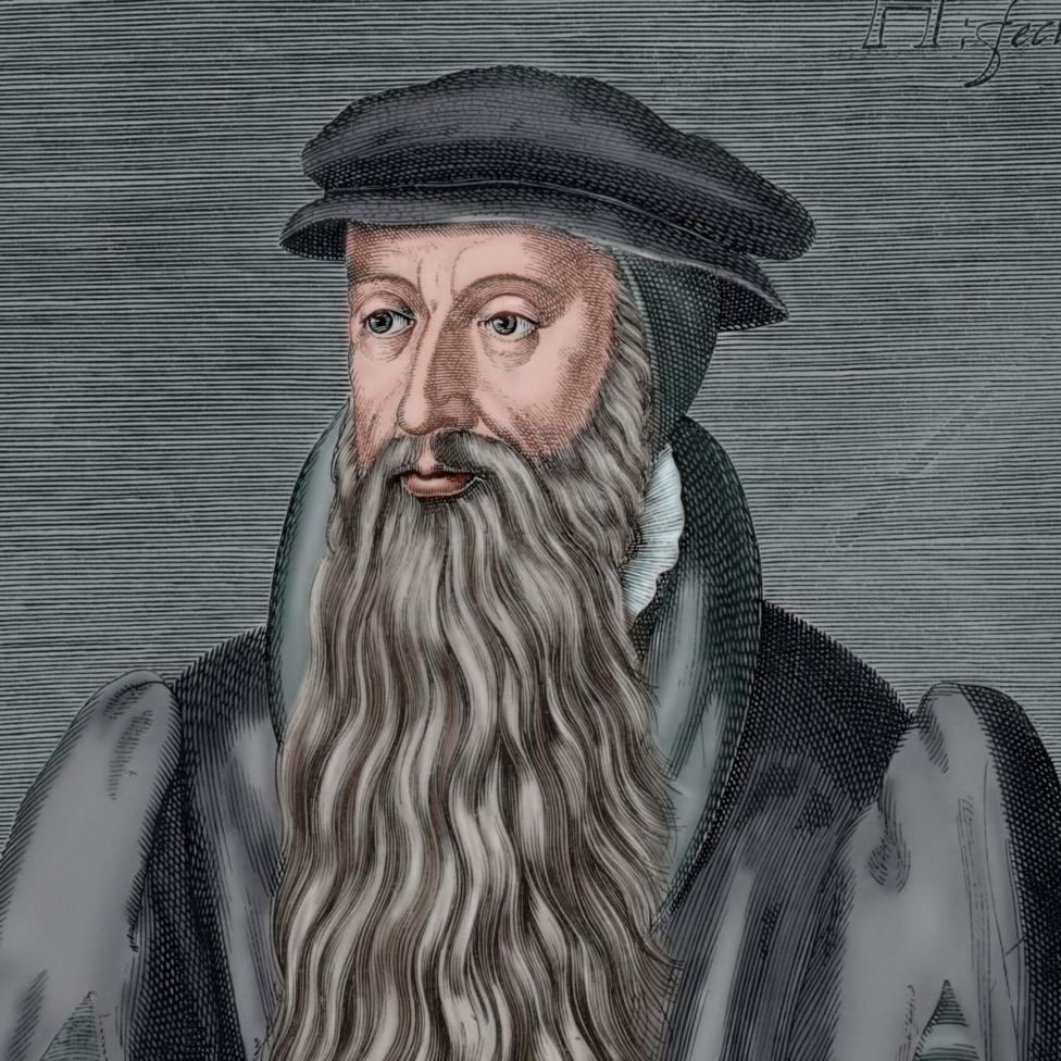 Illustrated historical portrait of a person wearing a dark flat cap and layered robe with broad shoulders, shown from the chest up. The person has a long, wavy beard extending down the front of the garment.