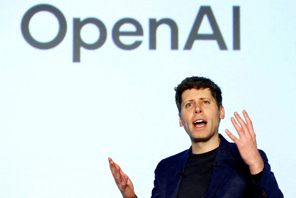 Altman speaking in front of an OpenAI sign 