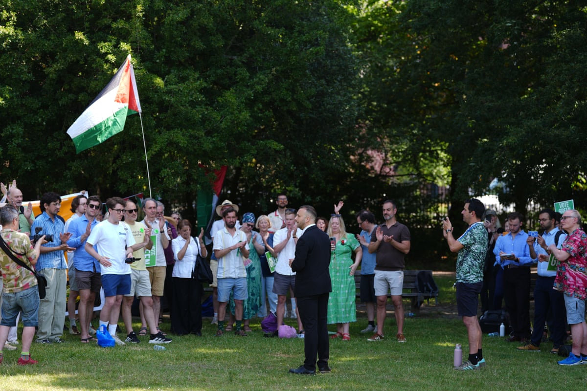 A Green rally in a London park attended by Polanski with a Gaza flag flying 