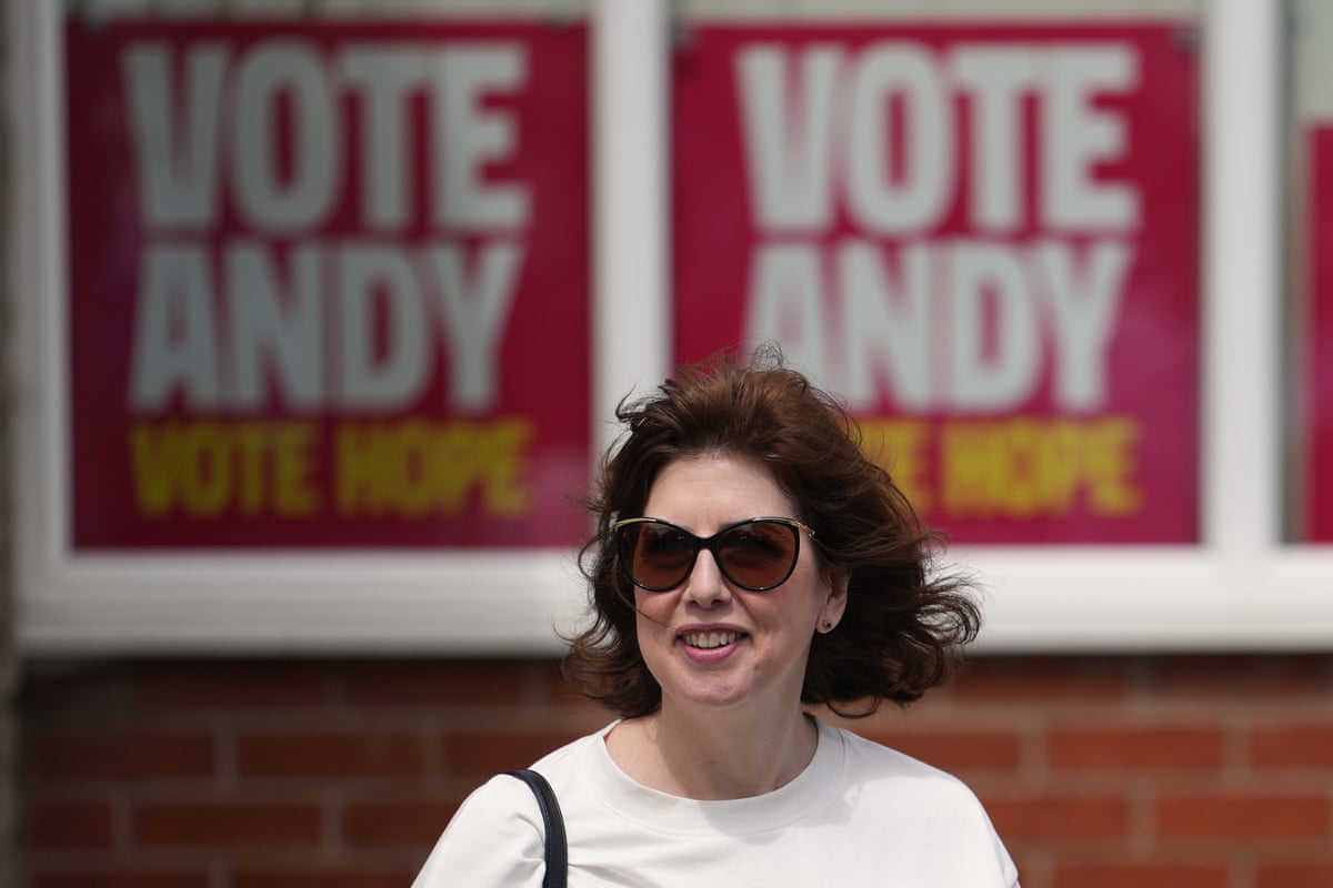 Lucy Powell in front of 'Vote Andy' posters