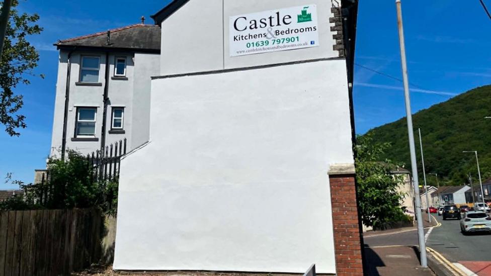A wall, which once bore a mural of Isambard Kingdom Brunel, painted white 