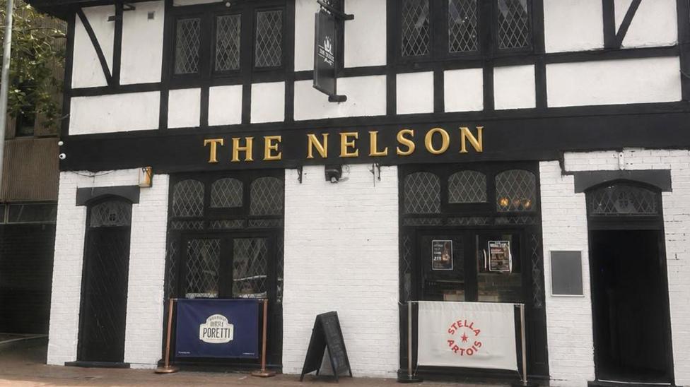 A pub seen from the outside on the street. The name reads: The Nelson.