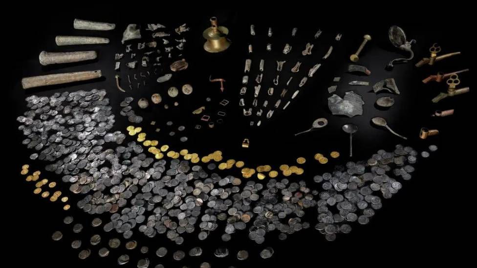 A picture of the artefacts line out, including gold and silver coins