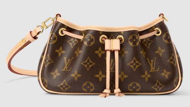 A brown Louis Vuitton handbag with the company's iconic graphics, including the four-petal flower monogram, printed across the leather 