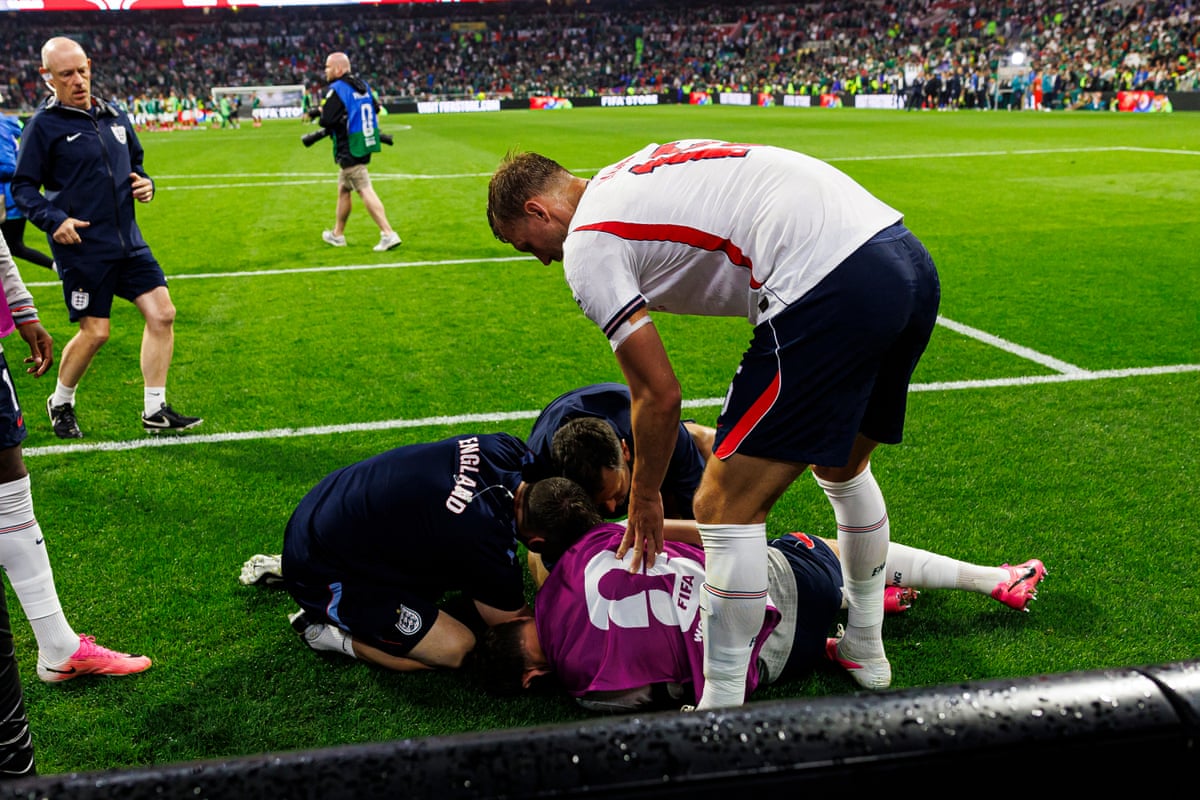 Dan Burn tries to help Jordan Henderson after the midfielder’s fall.