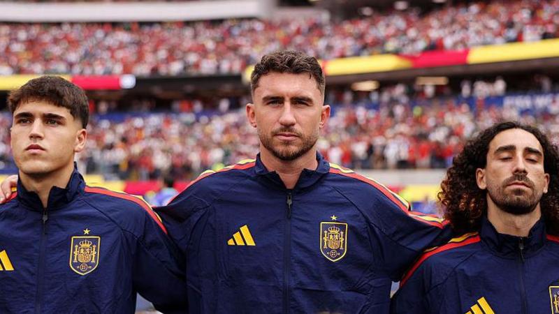 Spain defenders Pau Cubarsi, Aymeric Laporte and Marc Cucurella stand side by side during the national anthem before the World Cup match against Austria
