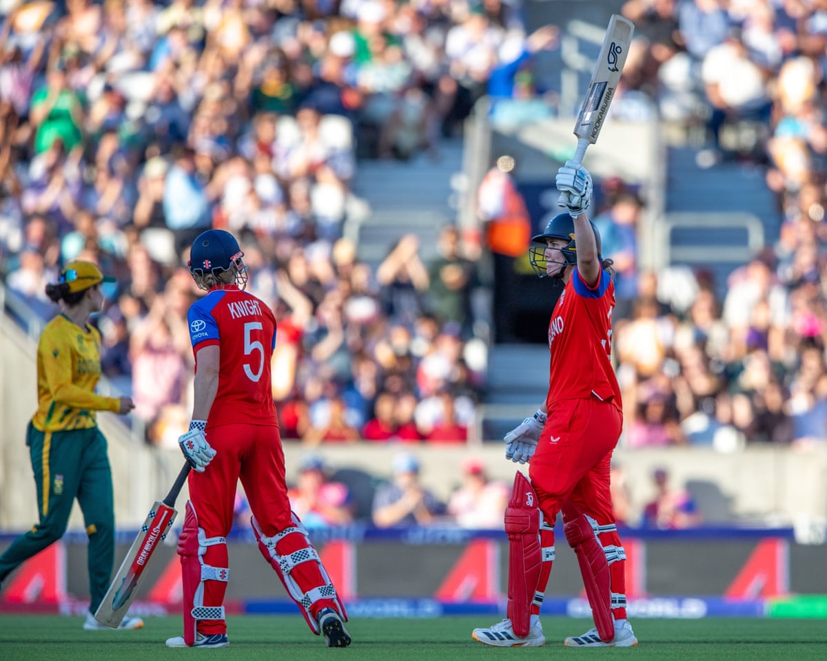The England batter Nat Sciver-Brunt (right) raises her bat to celebrate reaching a half-century in her team's Women's T20 World Cup semi-final win against South Africa at the Oval.