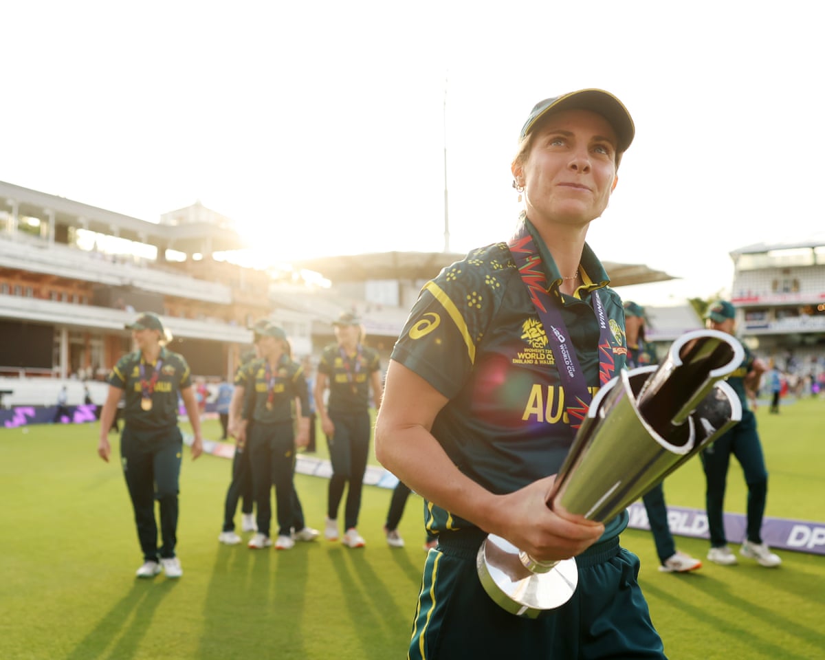 The Australia captain Sophie Molineux, holding the Women's T20 World Cup trophy, leads her team on a lap of honour around the boundary at Lord's after winning the final.