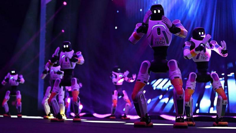 Agibot robots perform a routine on a stage at the VivaTech conference in Paris in 2026