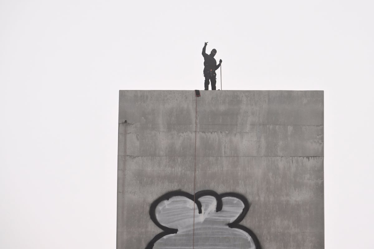 The man gestures on top of the eastern pylon of the Bolte Bridge in Melbourne.