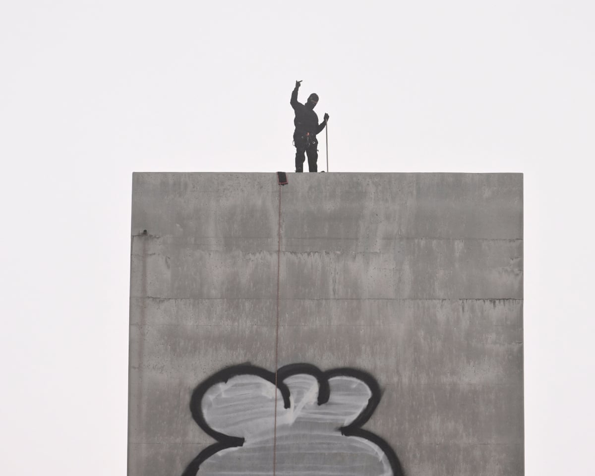 A man gestures from the top of the eastern pylon of the Bolte Bridge in Melbourne.