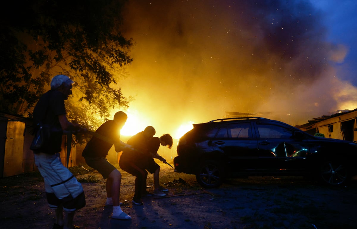 Kyiv residents battle flames after a Russian aerial assault.