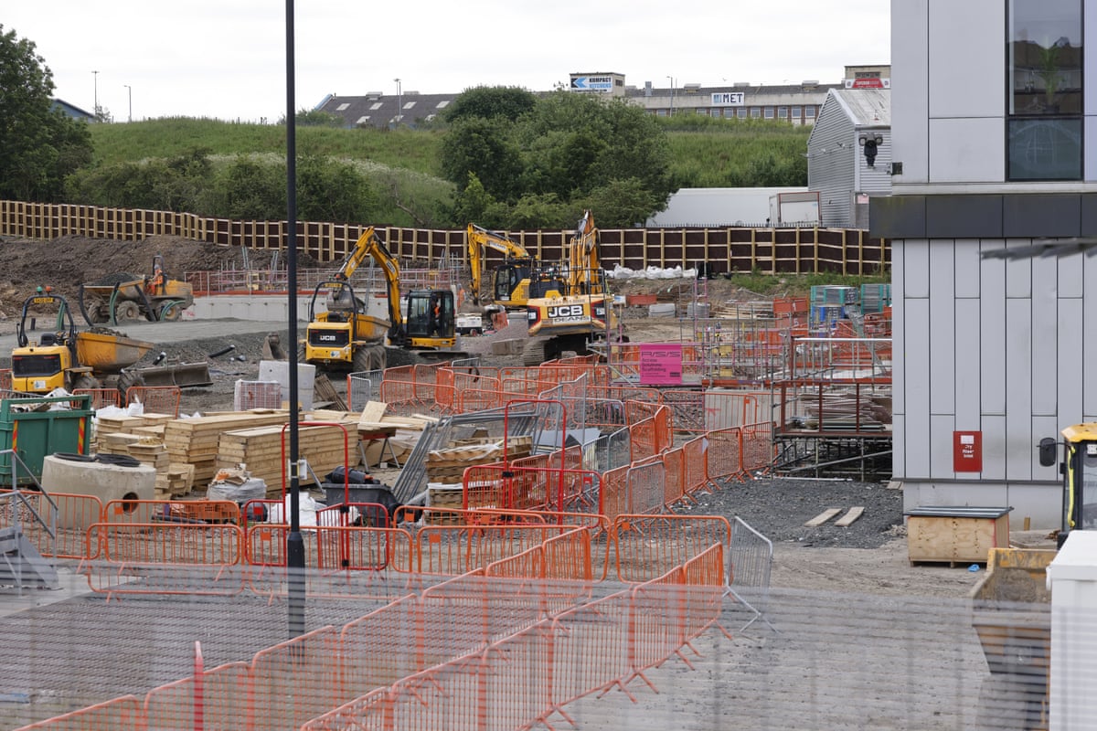 Construction work alongside a modern building