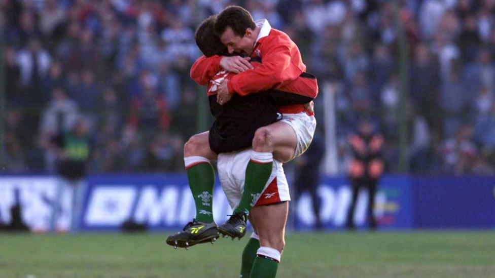 Rob Howley off the ground hugs a Wales team-mate on the successful tour of Argentina in 1999
