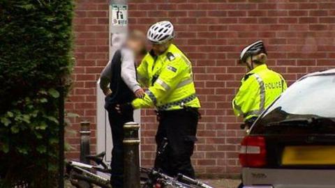 A police officer searching someone