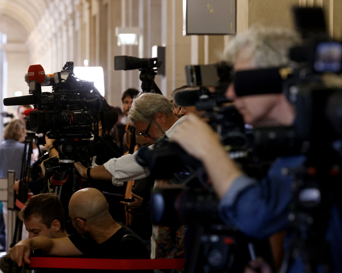 Journalists wait in a corridor ahead of a key verdict at Paris Court of appel.