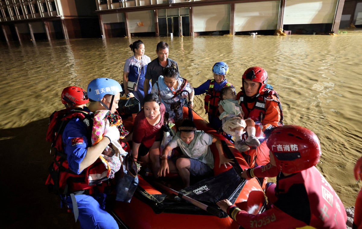 Rescue workers evacuate residents in a rubber dinghy after flood waters inundate villages in Hengzhou.