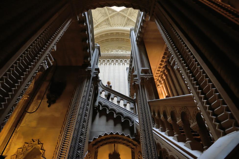 a large staircase with gothic elements throughouht
