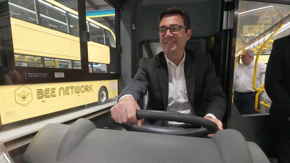 Andy Burnham drives a yellow