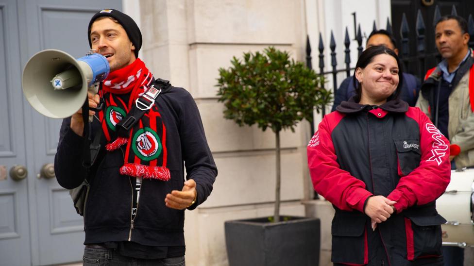 UK trade union boss Alex Marshall, left, holding a megaphone at a street protest