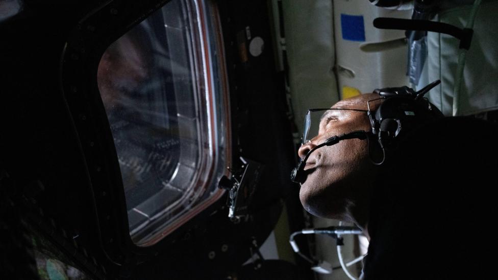  Victor Glover looks out of the window of the Orion spacecraft 