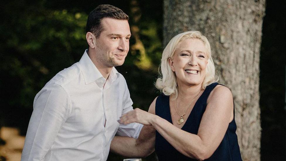 FRANCE-POLITICS-PARTIES-RN-LIEVIN Marine Le Pen president of the Rassemblement National RN parliamentary group smiles at the end of her speech alongside Jordan Bardella president of the Rassemblement National RN political party during a Fete champetre an event organised by the Rassemblement National RN in Lievin France on 4 July 2026