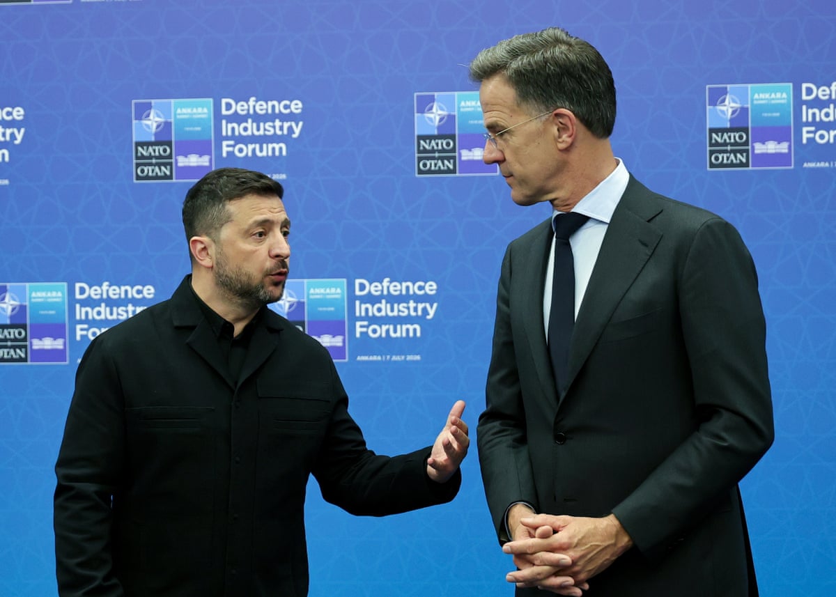 Zelenskyy raises a hand as he speaks to Rutte