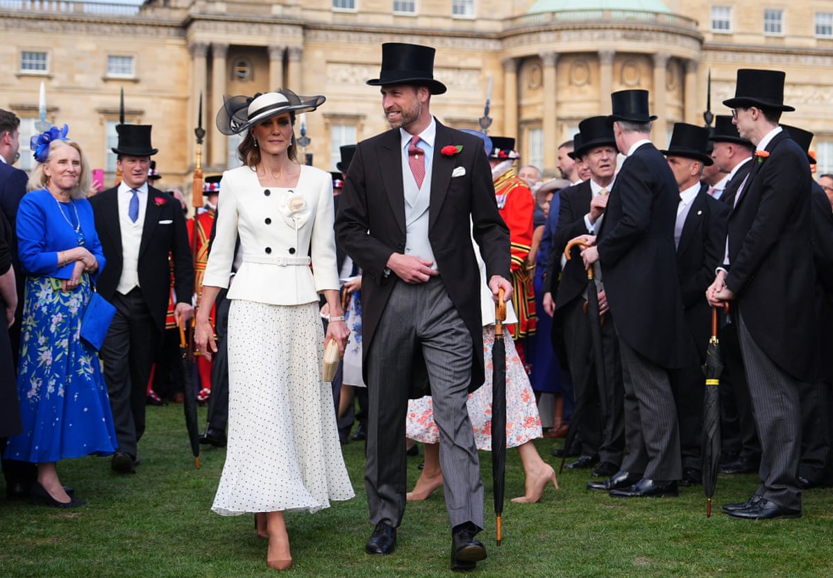 The Princess and Prince of Wales talk to guests at a garden party at Buckingham Palace