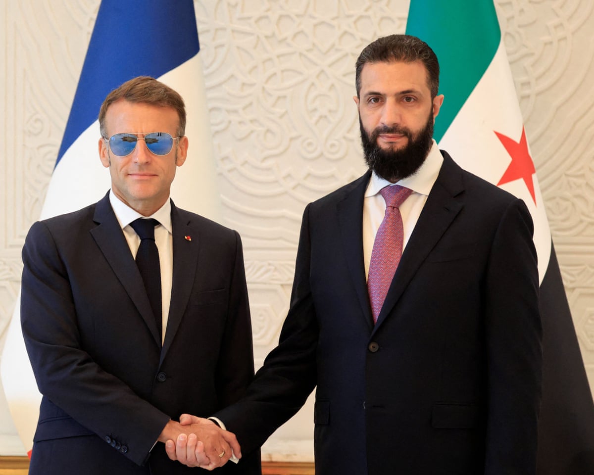 Emmanuel Macron and Ahmed al-Sharaa shake hands