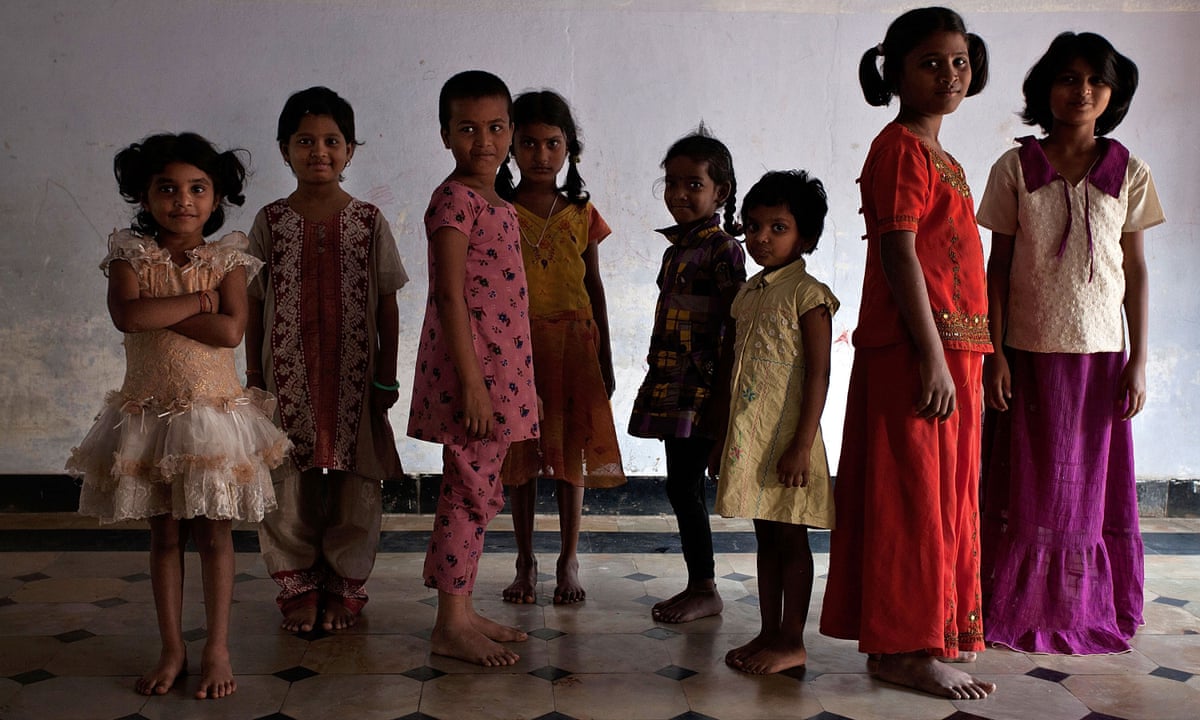 Eight young Indian girls of different ages pose for the camera