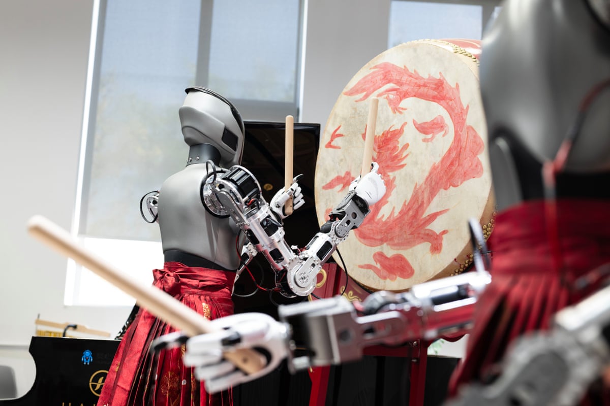 A humanoid robot wearing a traditional mamianqun skirt strikes a Chinese drum at the Linkerbot office in May in Beijing